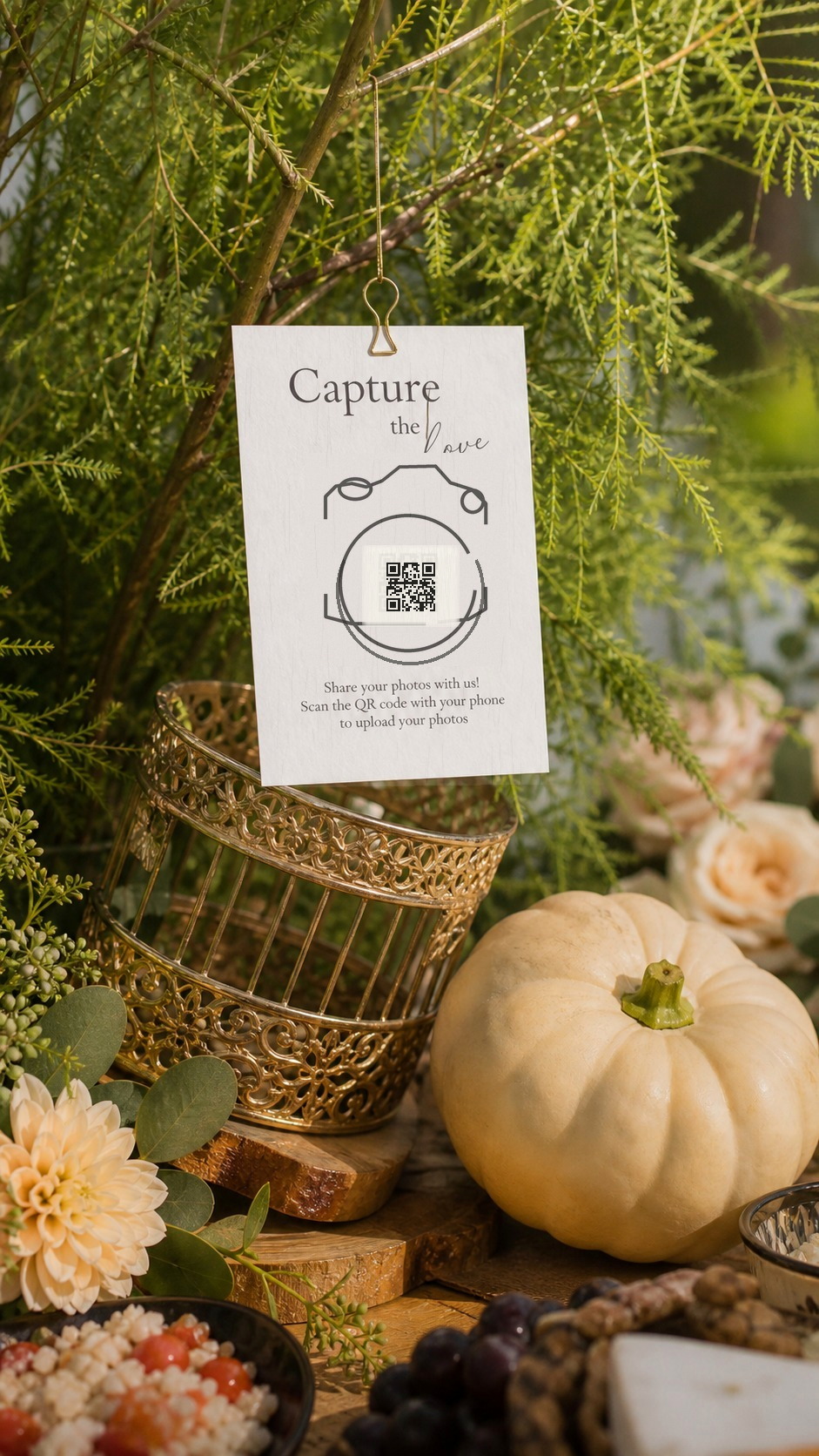 Forever Memories QR code card hanging in greenery at a wedding reception